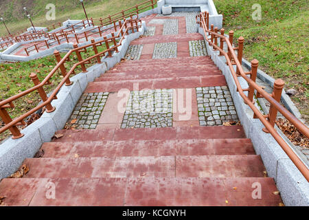 concrete steps ladder. On the stairs there are handrails. Photographed close-up. Stock Photo