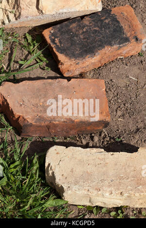 old clay bricks lying on the ground. Photo close up Stock Photo