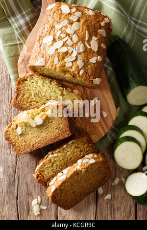 Gluten free zucchini loaf cake closeup on wooden background. Vertical top view from above Stock Photo