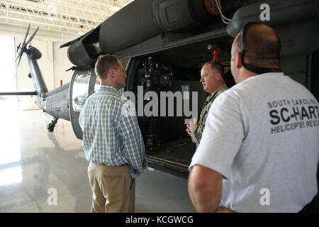 South Carolina Lieutenant Governor Kevin L. Bryant speaks with U.S. Army Chief Warrant Officer 4 Tripp Hutto, a UH-60 Blackhawk pilot, about the S.C. Helicopter Aquatic Rescue Team mission at McEntire Joint National Guard Base, July 21, 2017. Lt. Governor Bryant spoke with South Carolina Air and Army National Guard leadership about base missions and received a windshield tour of the installation with orientations of the various aircraft operated by South Carolina National Guard Airmen and Soldiers.  (U.S. Air National Guard photo by Master Sgt. Caycee Watson)