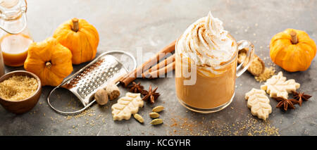 Pumpkin spice latte in a glass mug Stock Photo