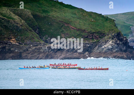 Gig racing - traditional Cornish Pilot Gigs racing off the coast of Newquay in Cornwall. Stock Photo