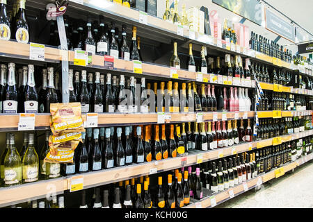 Bottles of alcohol on sale in a supermarket - shelves full of bottles of sparkling wine in a Morrisons Supermarket. Stock Photo