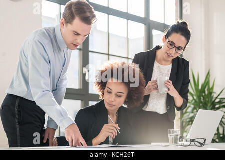 Young female employee asking for advice her experienced colleagu Stock Photo