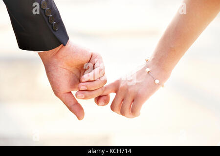 close-up shot of hands of a couple held together. Stock Photo