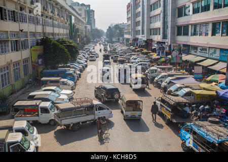 MANDALAY, MYANMAR - JANUARY 13, 2016: Side streets with parked minivans at the market in Mandalay , Myanmar on January 13, 2016. Stock Photo