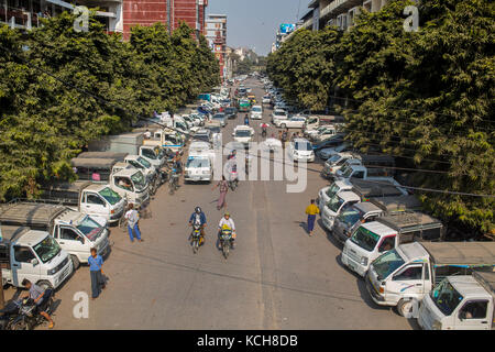 MANDALAY, MYANMAR - JANUARY 13, 2016: Side streets with parked minivans at the market in Mandalay , Myanmar on January 13, 2016. Stock Photo