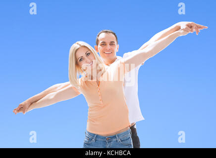 Portrait Of Loving Happy Couple Against Blue Sky Stock Photo