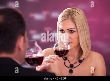Happy Beautiful Couple Enjoying Meal And Wine In Restaurant Stock Photo