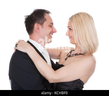 Couple Dressed In Formal Attire Stand Over White Background Stock Photo