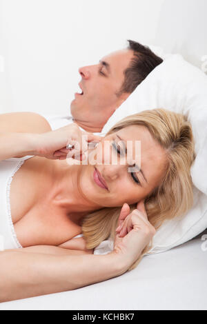 Portrait Of An Angry Woman Awaken By Her Boyfriend's Snoring Stock Photo