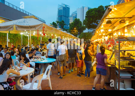 SINGAPORE - JAN 14, 2017 : People at a popular food court in Singapore. Inexpensive food courts are numerous in the city so most Singaporeans dine out a Stock Photo