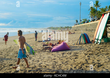 CANGGU, BALI ISLAND, INDONESIA - JAN 19, 2017: Surfers walking with surfboard on the beach. Bali island is one of the worlds best surfing destinations Stock Photo