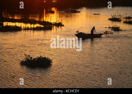 Silhouettes of fishermen in the sunset Stock Photo