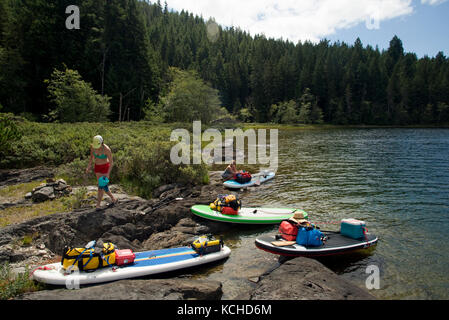 Stand-up paddleboard (SUP) touring in Main Lake Provincial Park, Quadra Island. British Columbia, Canada Stock Photo