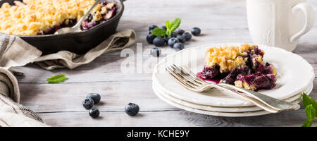 Coconut crumble in cast iron pan Stock Photo