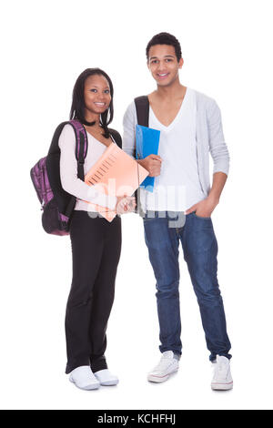 Two Students With Folder And Backpack Isolated Over White Background Stock Photo