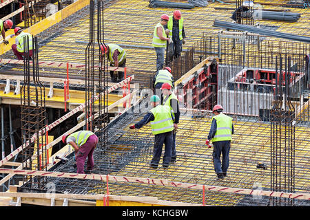 Group of men workers working at the construction site in Vilnius, Lithuania Stock Photo