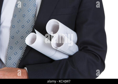 Portrait Of Happy Male Architect Holding Blueprints Stock Photo