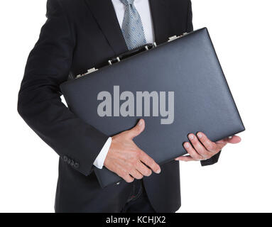 Close-up Of Businessman Holding Briefcase Over White Background Stock Photo