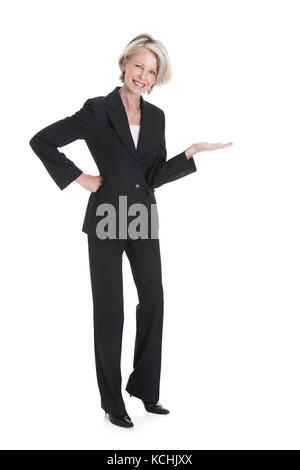 Portrait Of Happy Businesswoman Gesturing On White Background Stock Photo