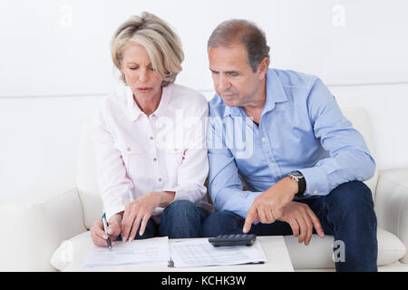 Mature couple doing family finances at home Stock Photo
