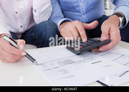 Close-up of mature couple doing finances at home Stock Photo