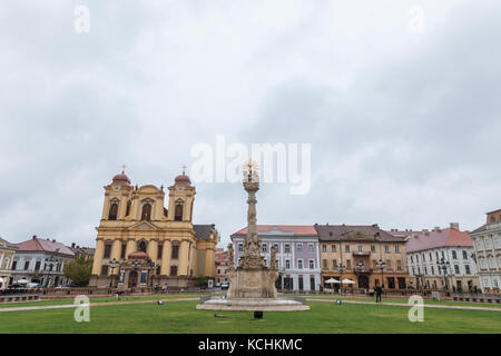 TIMISOARA, ROMANIA - SEPTEMBER 21, 2017: Unity Square (Piata unirii) taken during a cloudy autumn afternoon, the Saint George Roman Catholic church ca Stock Photo