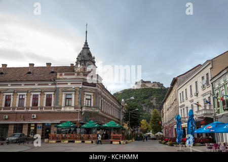 DEVA, ROMANIA - SEPTEMBER 21, 2017: Main street of the Transylvanian city of Deva. The castle of the city, on a hill, can be seen in the background  P Stock Photo