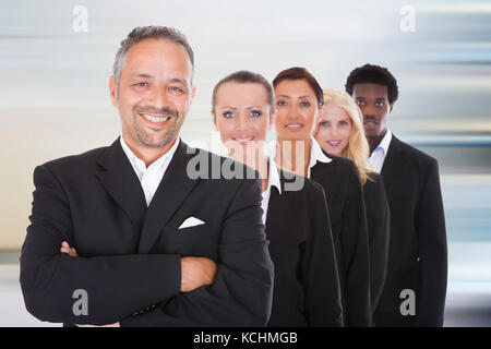 Happy Group Of Business People Standing In A Row At Office Stock Photo