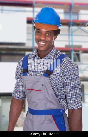Portrait Of A Young African Craftsman Wearing Blue Hardhat Stock Photo