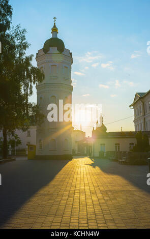 The beautiful view on Pochayiv Lavra courtyard during bright sunset with silhouette of churches domes, Ukraine Stock Photo