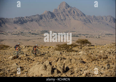 Competitors take part in the Trans Hajar mountain bike stage race in the Hajar mountains, Oman. Stock Photo