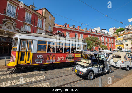 Historic tram 28 going by Largo Portas do Sol street in Alfama district. Lisbon, Portugal Stock Photo