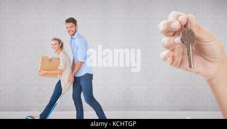 Digital composite of people moving boxes into new home with key Stock Photo