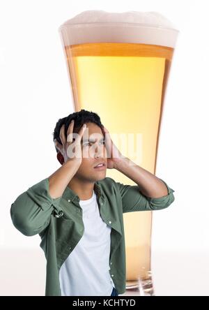 Digital composite of Man stressed and anxious with pint of beer Stock Photo