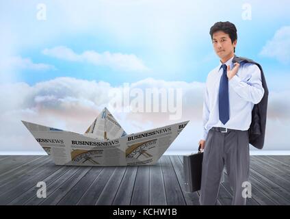 Digital composite of Paper boat with businessman in sky Stock Photo