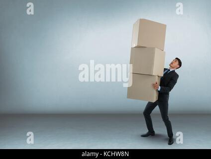 Digital composite of Businessman carrying boxes in room Stock Photo