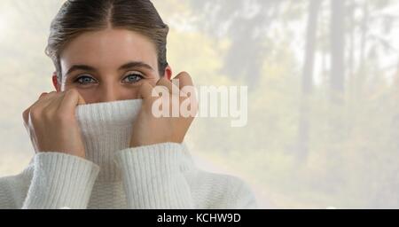 Digital composite of Woman in Autumn with jumper tight in bright forest Stock Photo