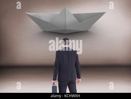 Digital composite of Businessman with briefcase and paper boat Stock Photo