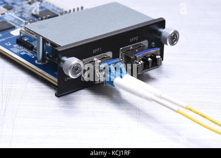 Gigabit interface converter type XFP with optical network cables on metal grey background with copy space Stock Photo