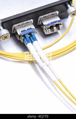 Gigabit interface converter type XFP with optical network cables on metal grey background with copy space Stock Photo