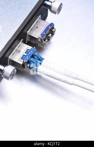 Gigabit interface converter type XFP with optical network cables on metal grey background with copy space Stock Photo