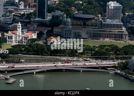 Singapore's heritage buildings in the city centre are:  L- R , The clock tower of the Victoria theatre and concert hall, ( lit by the sun), Singapore  Stock Photo