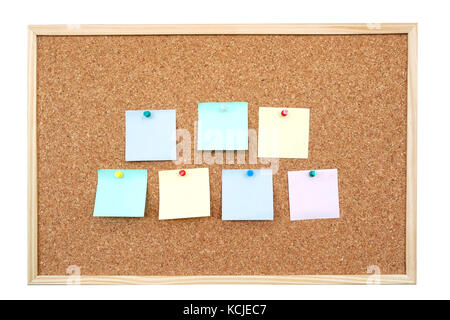 Seven colorful blank adhesive notes affixed to the corkboard - isolated on white Stock Photo