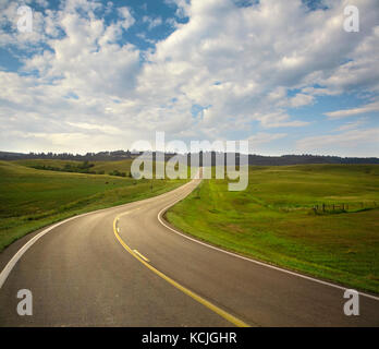 A curving road in the Black Hills area of South Dakota on a sunny afternoon Stock Photo