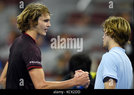 Beijing, China. 6th Oct, 2017. Alexander Zverev (L) of Germany and Andrey Rublev of Russia shake hands after the men's singles quarter-final match at the China Open tennis tournament in Beijing on Oct. 6, 2017. Credit: Ju Huanzong/Xinhua/Alamy Live News Stock Photo
