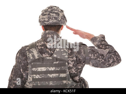 Man In Military Uniform Saluting Over White Background Stock Photo