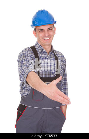 Happy Male Worker Extended Hand To Shake Over White Background Stock Photo