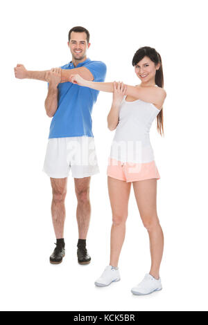 Happy Young Couple Exercising Over White Background Stock Photo
